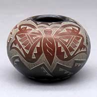 A black jar decorated with sienna spots and a sgraffito hummingbird, butterfly and geometric design
 by Candelaria Suazo of Santa Clara