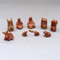 A thirteen piece miniature white on red Nativity scene with Navajo wise men
 by Linda Askan of Santa Clara