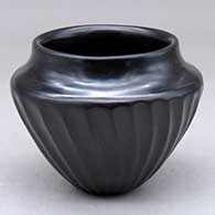 A small high shoulder black melon jar carved with 28 ribs
 by Joe Naranjo of Santa Clara