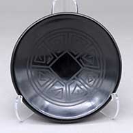 A small black on black piki bowl decorated inside with an angular spiral geometric design
 by Joe and Eunice Naranjo of Santa Clara