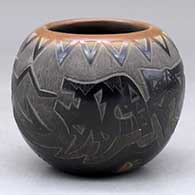 A small black bowl with a sienna rim and spots and decorated with a sgraffito avanyu, bear paw and geometric design
 by Justin Naranjo of Santa Clara