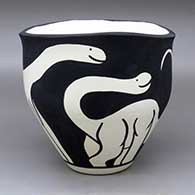 A black on white jar with an organic rim and decorated with a dinosaur design
 by William Pacheco of Santo Domingo