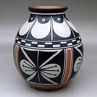 A polychrome jar with a flared rim and decorated with a four-panel butterfly and geometric design
 by Thomas Tenorio of Santo Domingo