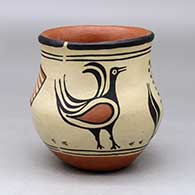 A polychrome jar decorated with a bird, plant and American flag design
 by Santana Melchor of Santo Domingo
