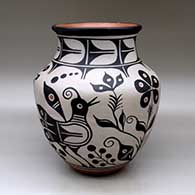 Click for a larger view A large polychrome jar with a recurved neck and decorated with a bird, plant, flower and geometric design
by Thomas Tenorio of Santo Domingo