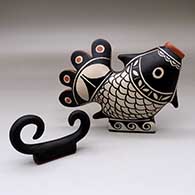 A two-piece polychrome fish and wave vignette
 by Thomas Tenorio of Santo Domingo