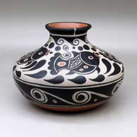 A low shouldered polychrome jar with a flared rim and decorated with a four panel fish, spiral and geometric design
 by Thomas Tenorio of Santo Domingo