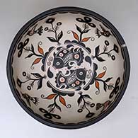 A large, deep polychrome bowl decorated inside with fish, birds, plants  and geometric design, and outside with spirals and water symbols
 by Thomas Tenorio of Santo Domingo