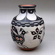 Click for a larger view A polychrome jar with a recurved neck and decorated with a bird, flower and geometric design
by Thomas Tenorio of Santo Domingo