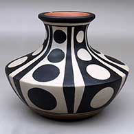 A low, wide-shouldered polychrome jar with a recurved neck and decorated with a six panel geometric design
 by Thomas Tenorio of Santo Domingo