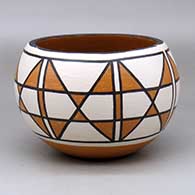 A polychrome bowl decorated around the body with a seven panel butterfly geometric design
 by Vicky Calabaza of Santo Domingo