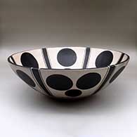 A large polychrome bowl decorated inside and out with a dot and bar geometric design
 by Thomas Tenorio of Santo Domingo