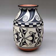 A polychrome jar with a flared neck and decorated with a six panel cotton flower, water wave and geometric design
 by Thomas Tenorio of Santo Domingo
