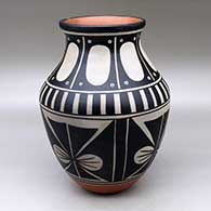 A polychrome jar decorated with a four panel butterfly and geometric design
 by Thomas Tenorio of Santo Domingo