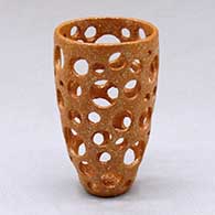 A small golden micaceous holey cylinder
 by Hubert Candelario of San Felipe