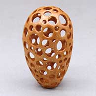 A small golden micaceous holey pot
 by Hubert Candelario of San Felipe