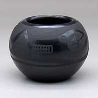 A black on black bowl decorated with an avanyu and geometric design
 by Marvin and Frances Martinez of San Ildefonso