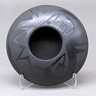 A black on black bowl decorated with an avanyu and pueblo design above the shoulder
 by Marvin and Frances Martinez of San Ildefonso