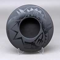 A black on black bowl decorated with an avanyu and geometric design above the shoulder
 by Marvin and Frances Martinez of San Ildefonso