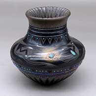 A black on black jar decorated with carved ribs, a sgraffito avanyu and geometric design, strands of inlaid heishi beads and multiple inlaid stones
 by Russell Sanchez of San Ildefonso