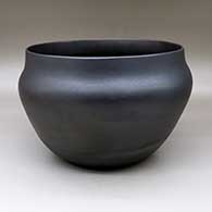A large micaceous black serving bowl with fire clouds
 by Clarence Cruz of Ohkay Owingeh