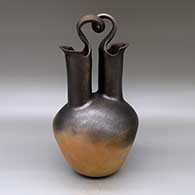 A golden micaceous wedding vase with fire clouds and a looped bridge
 by Eric Marcus of Taos