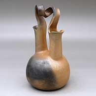 A golden micaceous wedding vase with fire clouds and a looped bridge
 by Eric Marcus of Taos