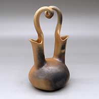 A golden micaceous wedding vase with fire clouds and a looped bridge
 by Eric Marcus of Taos