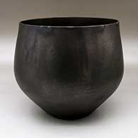 A black micaceous hair washing bowl with fire clouds
 by Angie Yazzie of Taos