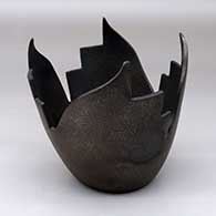 A micaceous black sculptural piece with four kiva step and geometric cut sides
 by Angie Yazzie of Taos