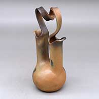 A golden micaceous wedding vase with a looped bridge and fire clouds
 by Eric Marcus of Taos