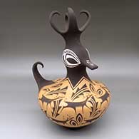 A polychrome duck pot with a four-feather crown and decorated with a deer-with-heart-line, mountain, forest, rain cloud and geometric design
 by Anderson Peynetsa of Zuni