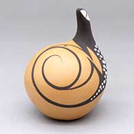 A polychrome seed pot decorated with a lizard head applique and lizard and geometric design
 by Anderson Peynetsa of Zuni