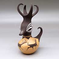 Click for a larger view A small polychrome, feather-crested duck pot decorated with a deer-with-heart-line and geometric design
by Anderson Peynetsa of Zuni