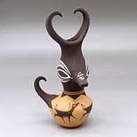 Click for a larger view A small polychrome, feather-crested duck pot decorated with a deer-with-heart-line and geometric design
by Anderson Peynetsa of Zuni