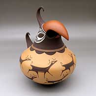 A polychrome parrot effigy jar decorated with a deer-with-heart-line and geometric design
 by Anderson Peynetsa of Zuni