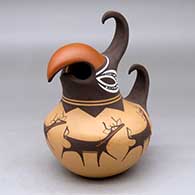 A polychrome parrot effigy jar decorated with a deer-with-heart-line and geometric design
 by Anderson Peynetsa of Zuni
