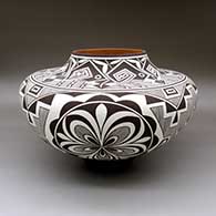 A large polychrome jar decorated with a black on white rosette, fineline and geometric design
 by Anderson Jamie Peynetsa of Zuni