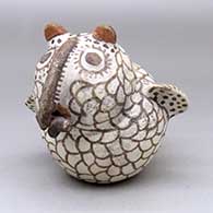 A polychrome owl figure with a creature in its beak
 by Unknown of Zuni