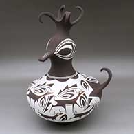 Click for a larger view A polychrome duck pot decorated around the body with a deer with heart line and geometric design
by Anderson Peynetsa of Zuni