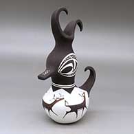 A polychrome duck pot decorated around the body with a deer with heart line and geometric design
 by Anderson Peynetsa of Zuni