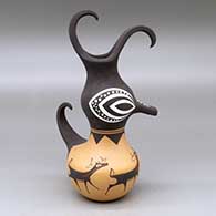 A polychrome duck pot decorated around the body with a deer with heart line and geometric design
 by Anderson Peynetsa of Zuni