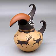 Click for a larger view A polychrome parrot pot decorated around the body with a deer with heart line and geometric design
by Anderson Peynetsa of Zuni
