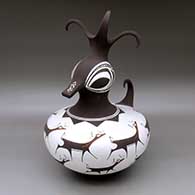 A large polychrome duck pot decorated with a deer with heart line and geometric design
 by Anderson Peynetsa of Zuni