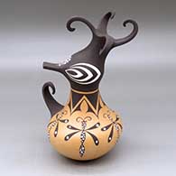 A polychrome duck pot decorated around the body with a dragonfly and geometric design
 by Anderson Jamie Peynetsa of Zuni