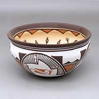 A polychrome bowl decorated inside with a frog, tadpole and geometric design, and outside with a three panel rainbird, rainbow and geometric design
 by Carlos Laate of Zuni