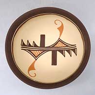 A polychrome bowl decorated outside with a four panel bird element and geometric design and inside with a geometric design
 by Carlos Laate of Zuni