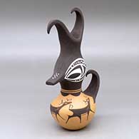 A small duck effigy pot with a feathered crown and decorated with a deer with heart line and geometric design
 by Anderson Peynetsa of Zuni