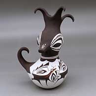 A small duck effigy pot with a feathered crown and decorated with a mountain, forest, deer with heart line and geometric design
 by Anderson Peynetsa of Zuni
