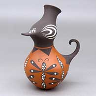 A small polychrome duck effigy decorated with a dragonfly and geometric design
 by Anderson Jamie Peynetsa of Zuni